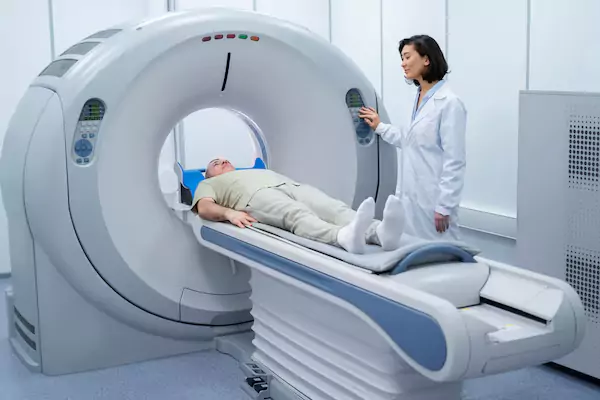 Female student guiding patient for CT scan in Diploma in Radiation Technology training.